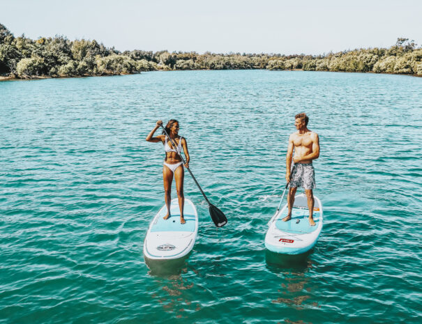 Couple enjoying a stand up paddleboarding experience in Fingal Head, Tweed
