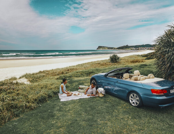 Couple enjoying a picnic overlooking Lennox Head Beach, Lennox Head.